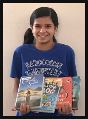 Narcoossee Elementary  student holding several books 